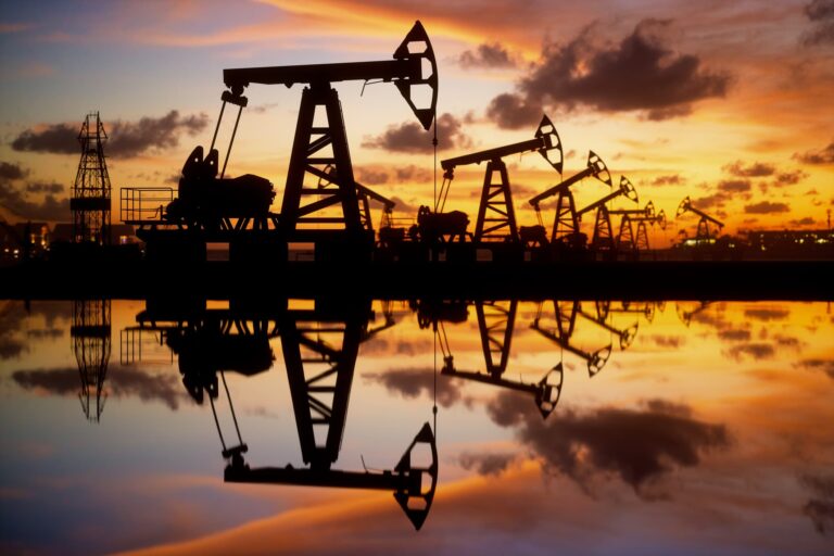 107065218-1653293244892-gettyimages-1323151704-oil-pumps-and-rig-at-sunset